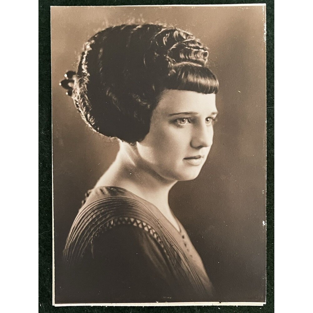 1920s Profile Photo of Woman Elaborate Updo Hairstyle Sepia-toned Pleated Dress